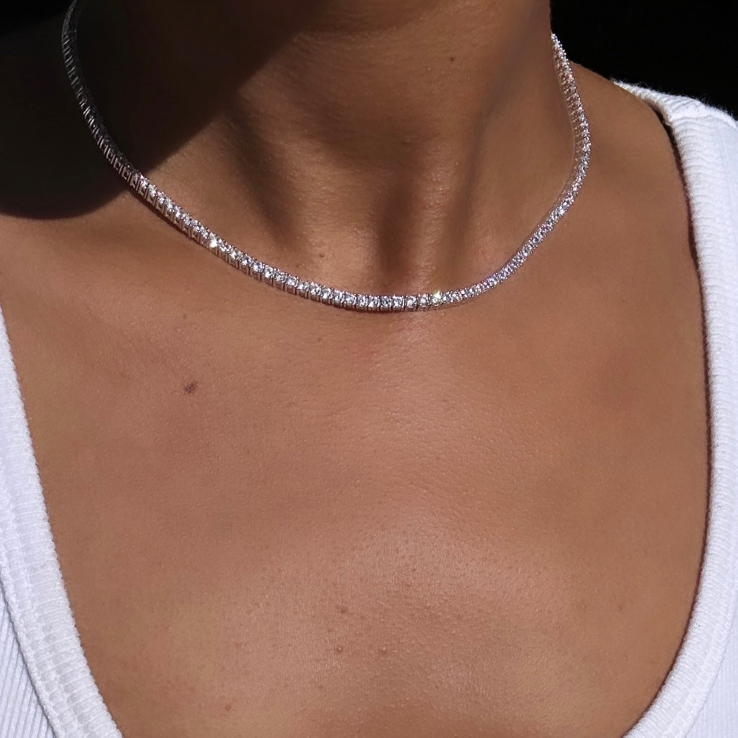 Our white gold diamond tennis necklace on a neck