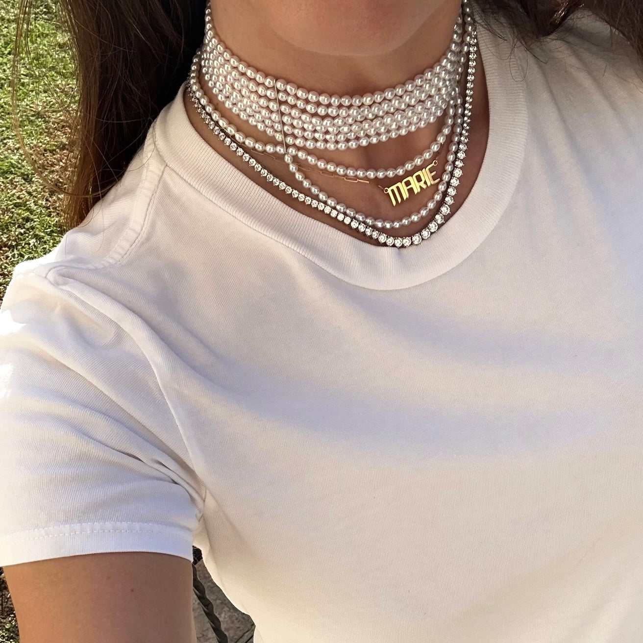 Choker with pearl necklace shown with tennis and gold nameplate necklace