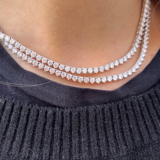 Two of our zircon 3mm tennis necklaces on a neck