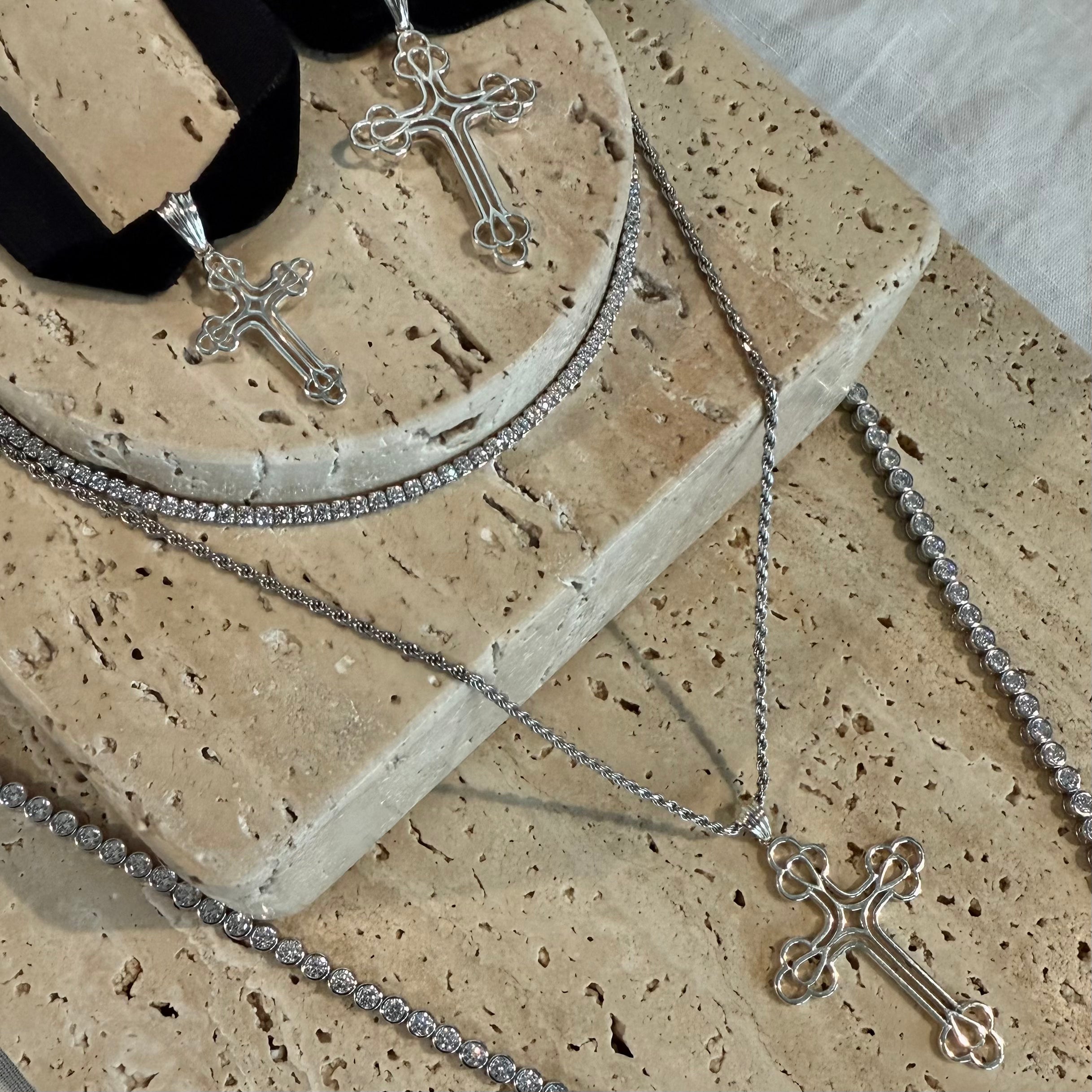 Three silver cross pendants with black velvet ribbon choker