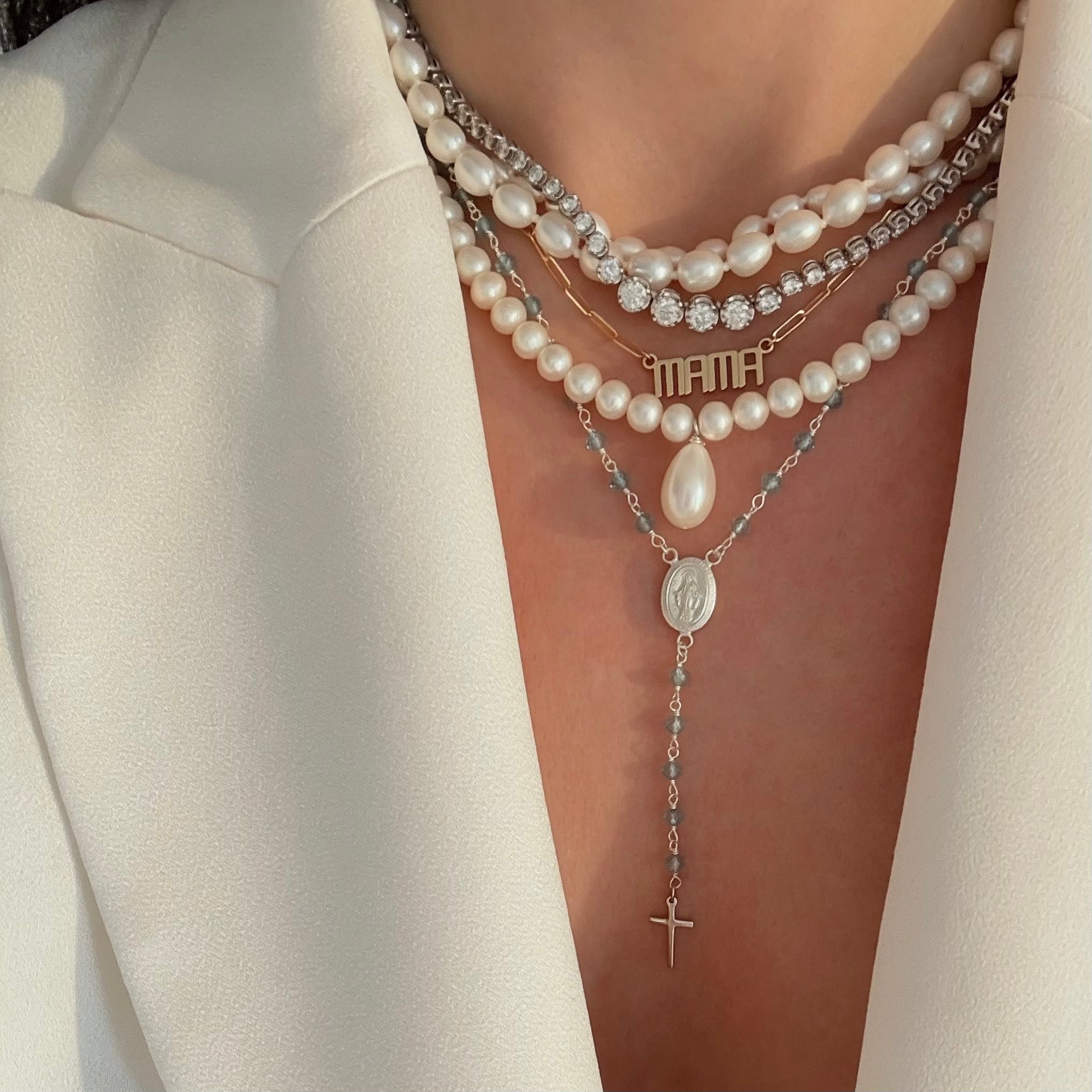 Blue rosary styled with pearl necklaces