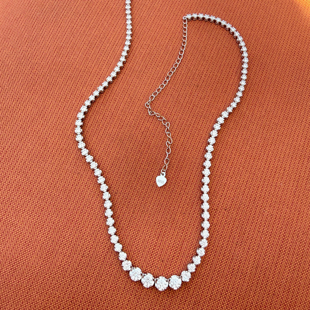 Graduated tennis necklace with silver extension chain