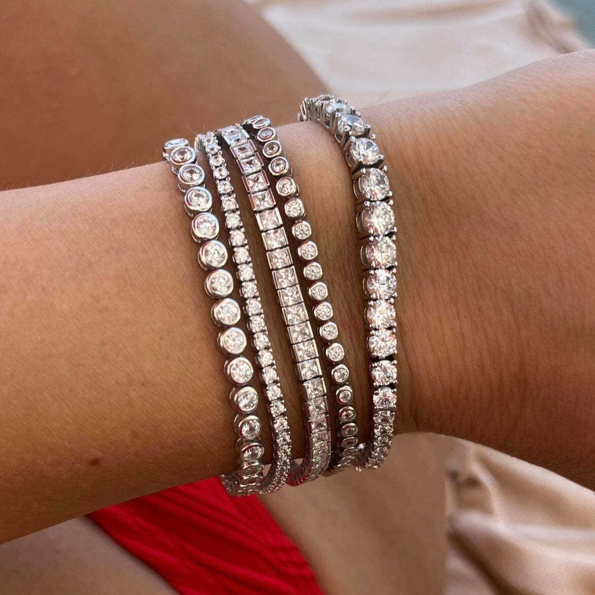 Five of our Leni James tennis bracelets on a wrist
