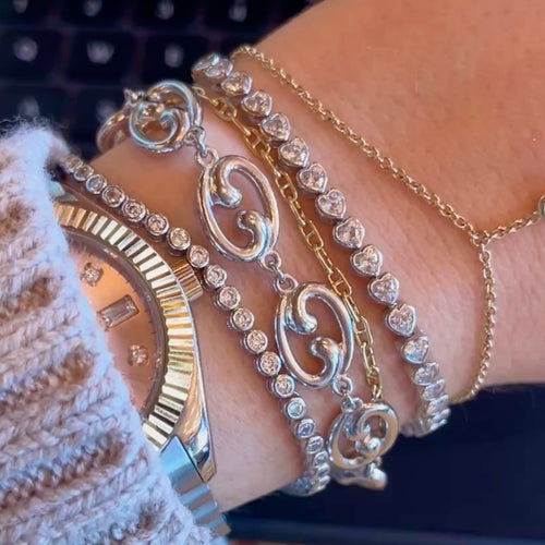 Our Fibonacci link bracelet with 2 tennis bracelets and thin gold chains