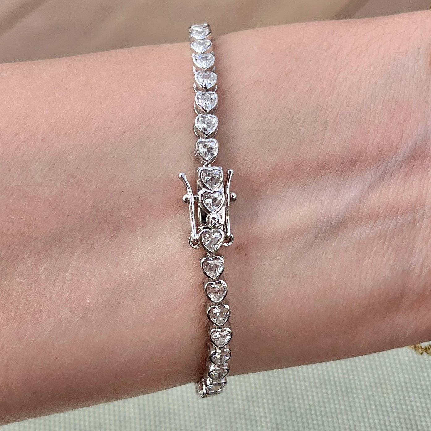 Clasp for our heart bezel tennis bracelet shown on wrist