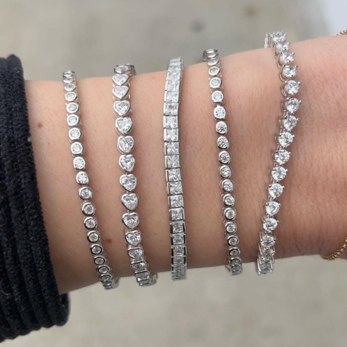 Tennis bracelets stack on a wrist