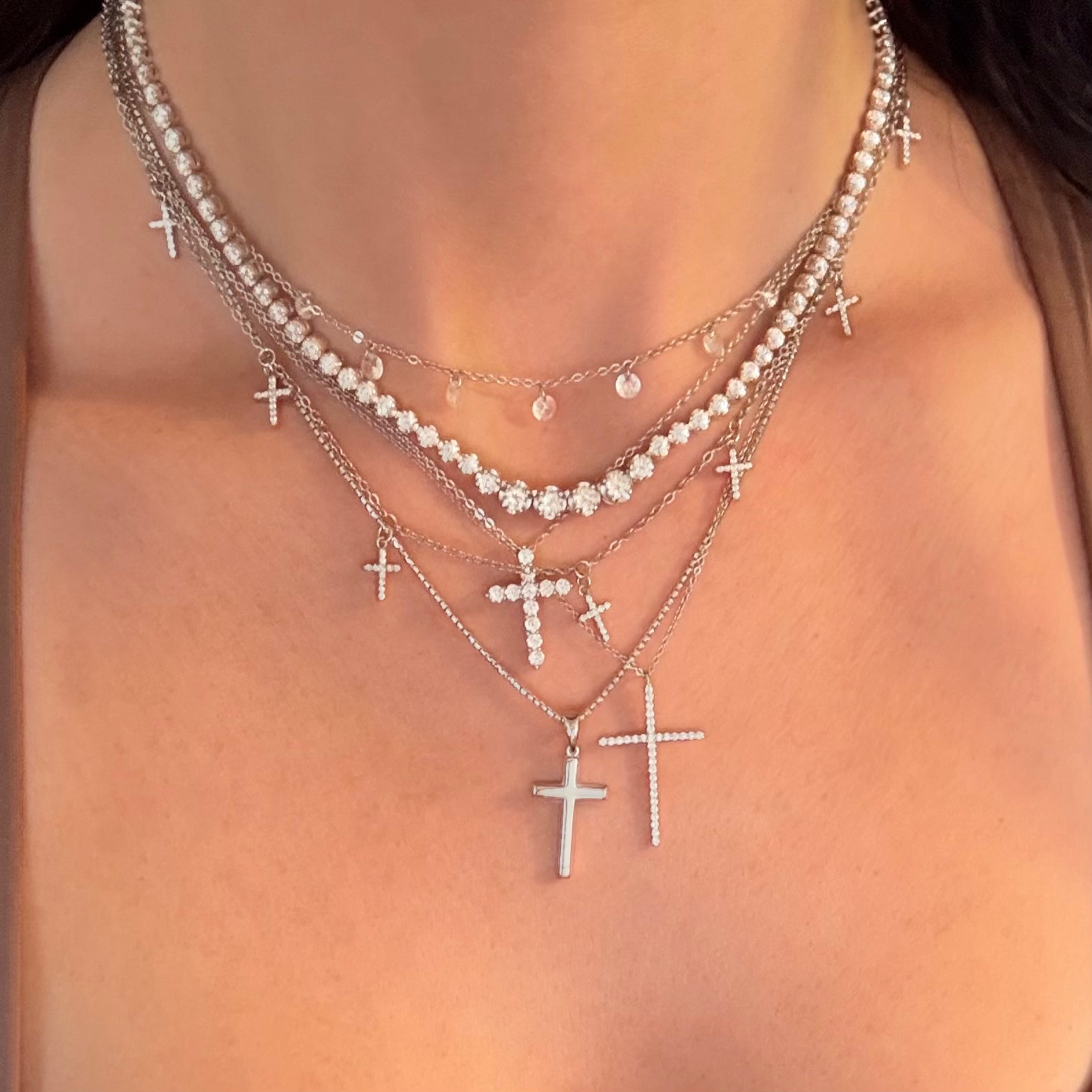 Layers of cross necklaces 