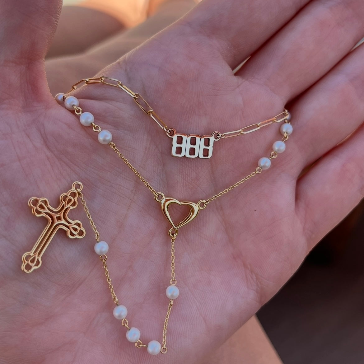 Pearl rosary with gold heart and cross, and an angel number 888 nameplate necklace