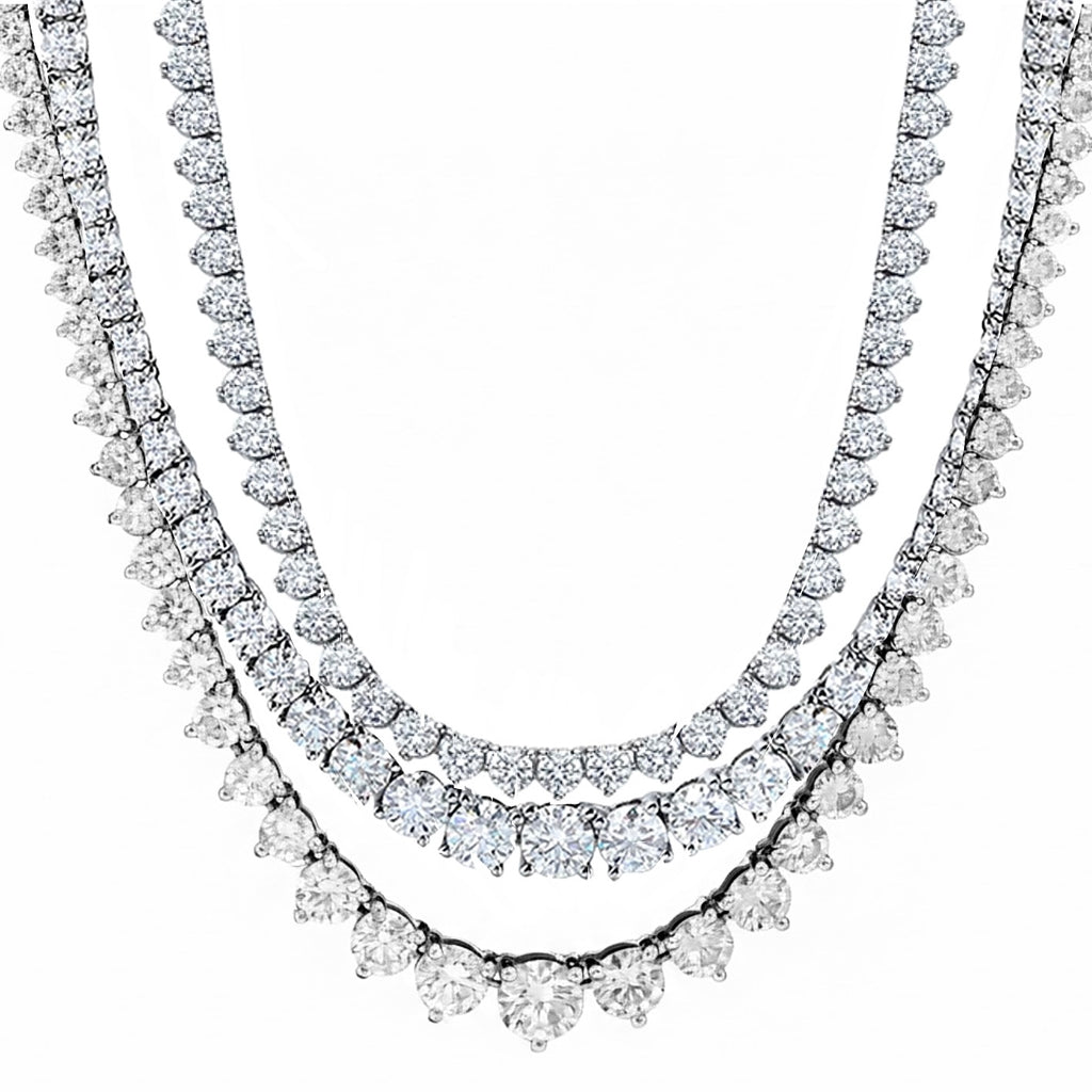 Three diamond necklace set on a white background