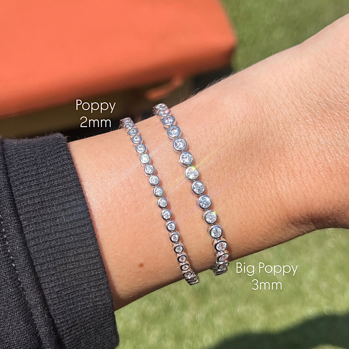 2mm and 3mm size comparison of two round bezel tennis bracelets on a wrist 
