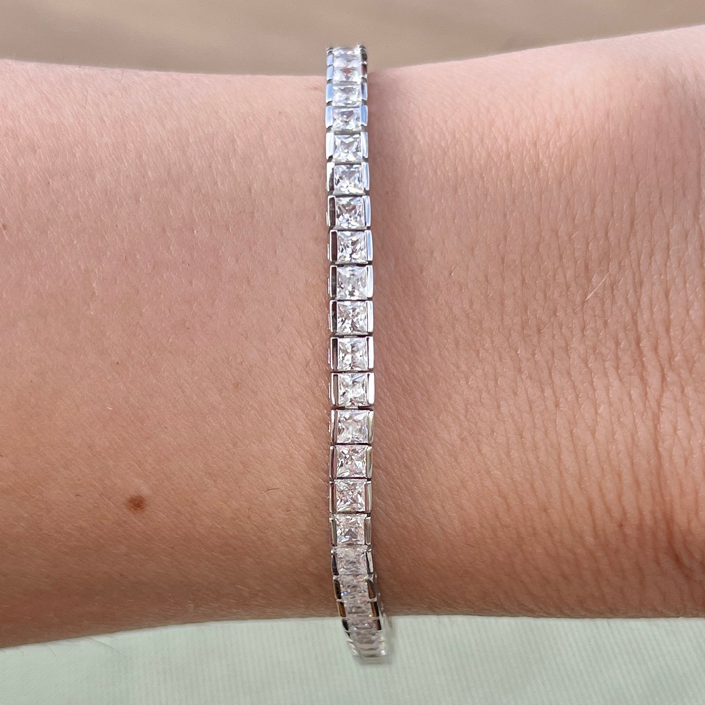 Our princess cut channel set tennis bracelet shown on wrist