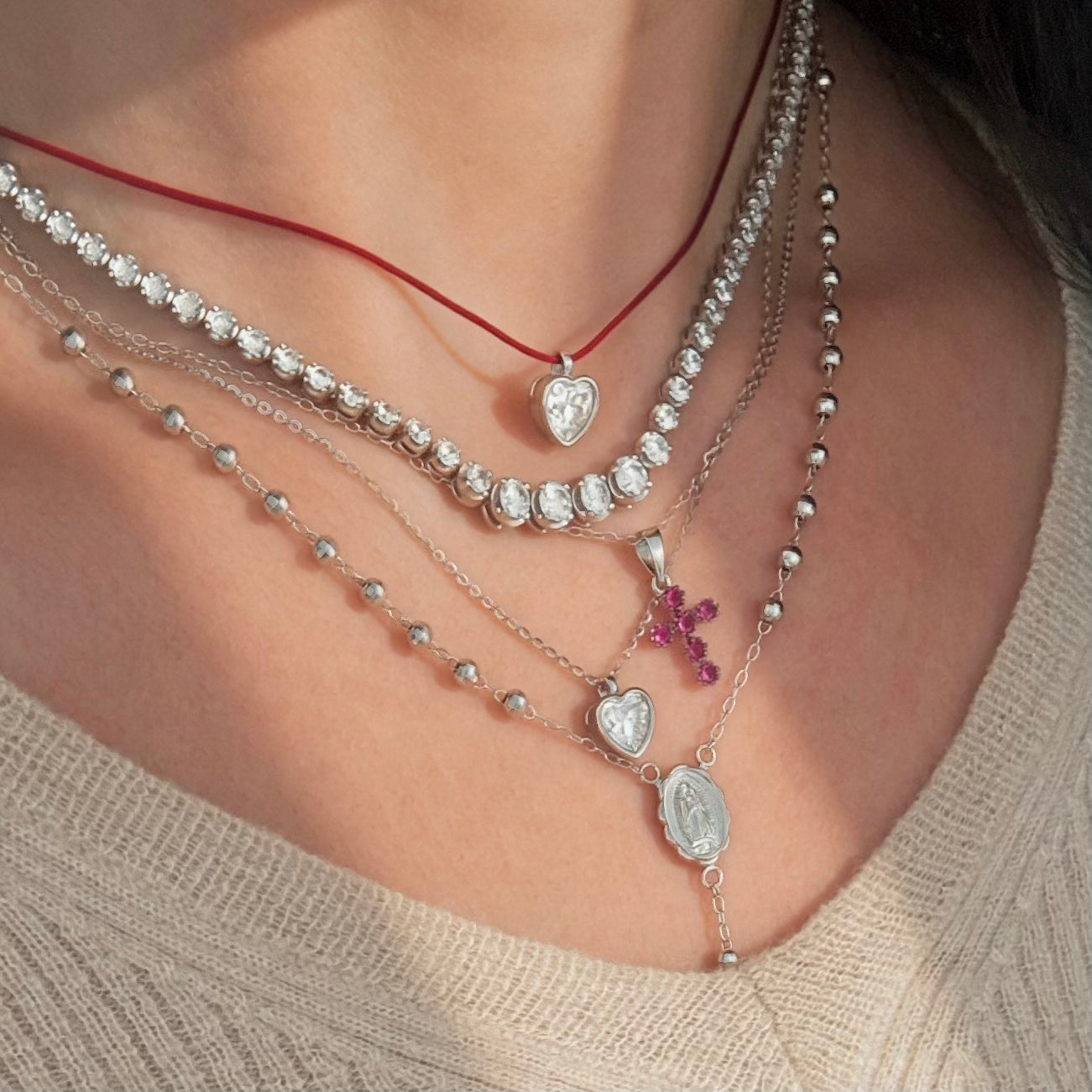 Heart bezel necklaces with a tennis necklace and pink cross pendant 