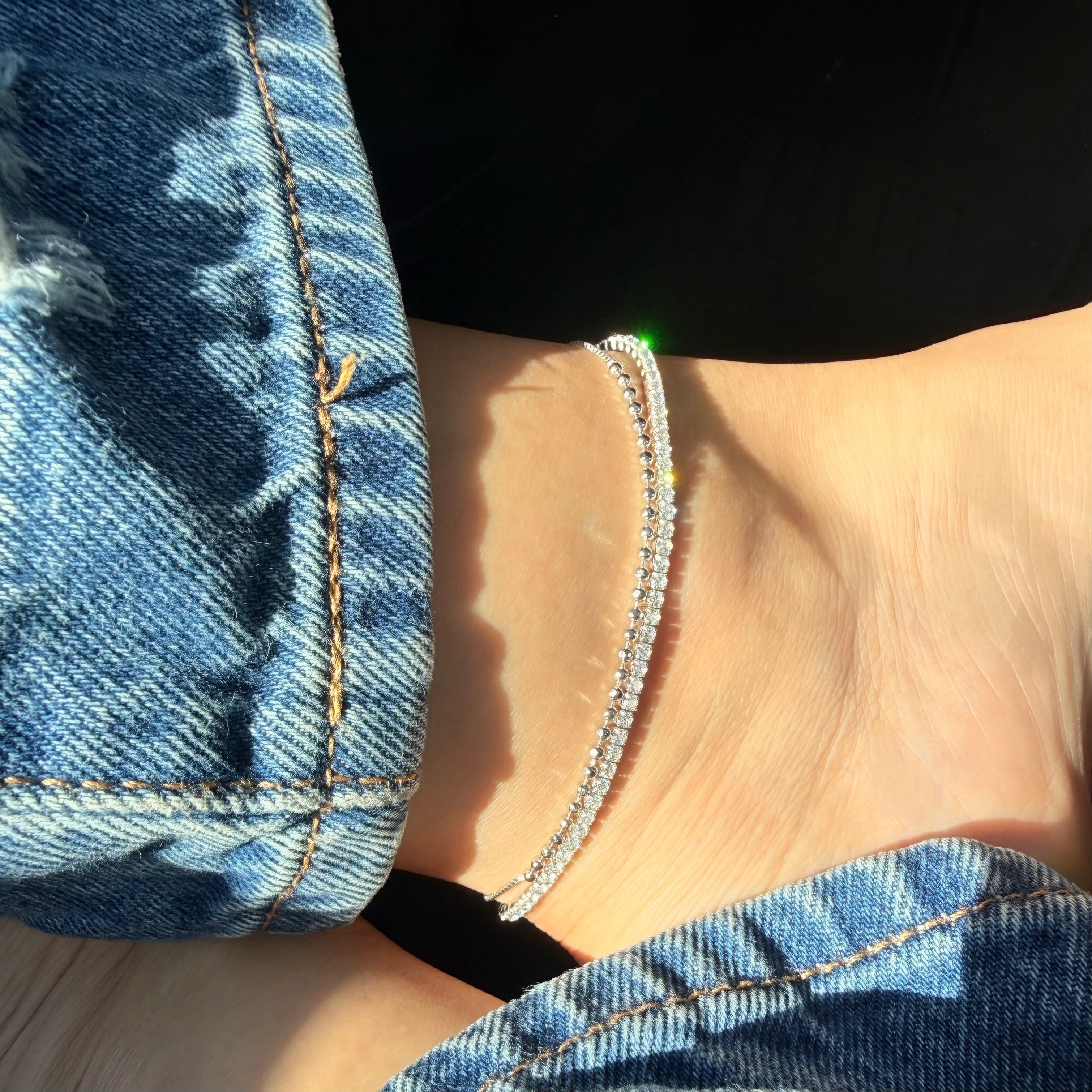 Tennis anklet and silver beaded anklet styled with jeans 