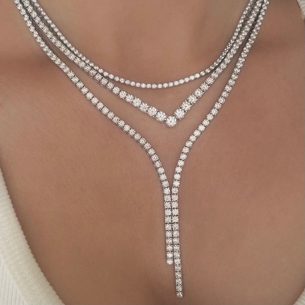 Y-shaped diamond necklaces on a model's neck