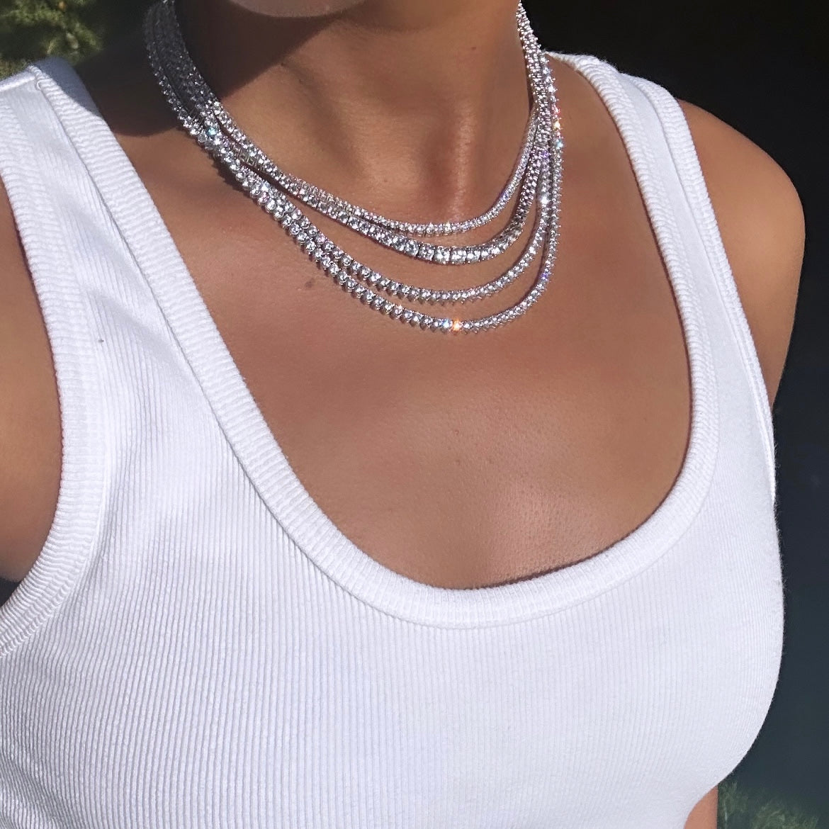 Our lab created diamond tennis necklaces shown on a neck