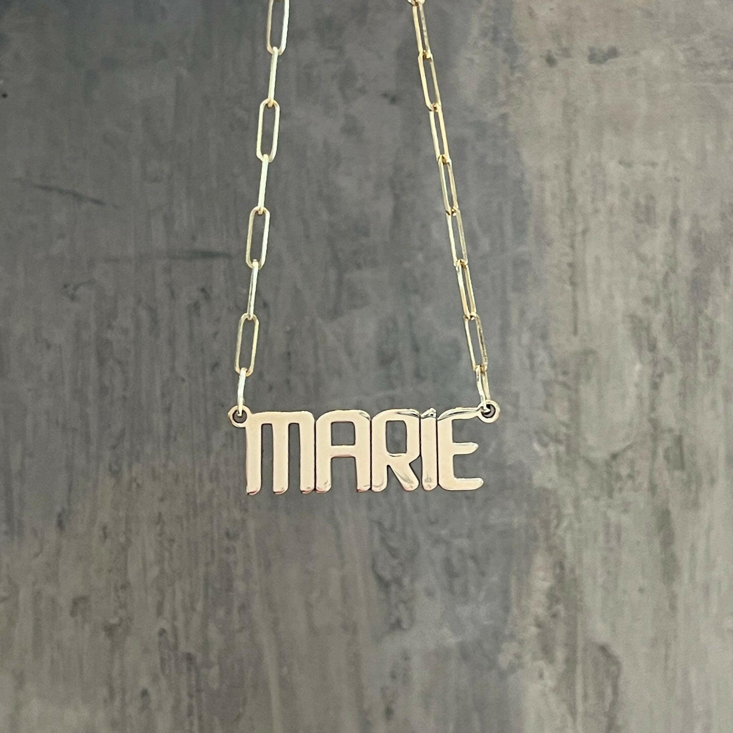 Closeup of our custom nameplate necklace with our signature font