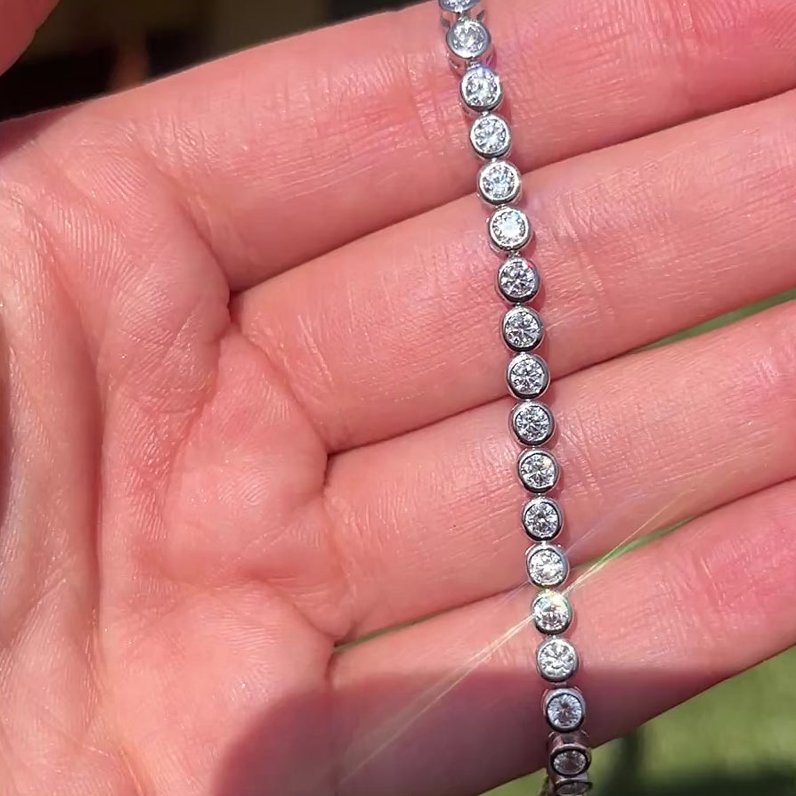 Closeup of our 3mm big poppy round bezel tennis bracelet 
